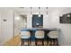 Modern bar area with a sink, stylish pendant lighting, seating and marble counter at 3801 N Goldwater Blvd # 201, Scottsdale, AZ 85251