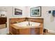 Bathroom featuring a large corner tub with tile surround and decorative accents at 3801 N Goldwater Blvd # 201, Scottsdale, AZ 85251
