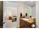 Bathroom with brown vanity and a bedroom in the background at 3801 N Goldwater Blvd # 201, Scottsdale, AZ 85251