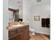 Well-lit bathroom with a large mirror, tile accents, and neutral walls at 3801 N Goldwater Blvd # 201, Scottsdale, AZ 85251