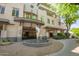 Building exterior with decorative water feature and landscaping, adding elegance to the entrance at 3801 N Goldwater Blvd # 201, Scottsdale, AZ 85251