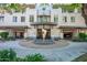 Beautiful building entrance featuring an art sculpture, fountain, and well-maintained landscaping at 3801 N Goldwater Blvd # 201, Scottsdale, AZ 85251