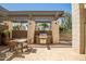 Outdoor grilling area with seating and a pergola, perfect for summer gatherings at 3801 N Goldwater Blvd # 201, Scottsdale, AZ 85251