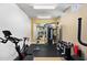 Well-equipped fitness center with stationary bike, weight training equipment and large mirrors for a healthy lifestyle at 3801 N Goldwater Blvd # 201, Scottsdale, AZ 85251