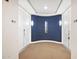 Residential hallway with double front doors, unit numbers and wall sconces creating a modern entrance at 3801 N Goldwater Blvd # 201, Scottsdale, AZ 85251
