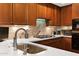 Gourmet kitchen boasts custom wood cabinets, modern stainless steel appliances, and white marble countertops at 3801 N Goldwater Blvd # 201, Scottsdale, AZ 85251