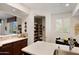 Bright kitchen with white countertops, custom wood cabinets, stainless steel sink, and a view of a pantry at 3801 N Goldwater Blvd # 201, Scottsdale, AZ 85251