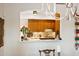 Pass-through view of a kitchen featuring wood cabinets and backsplash at 3801 N Goldwater Blvd # 201, Scottsdale, AZ 85251