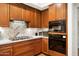 This modern kitchen features updated stainless steel appliances, custom wood cabinets, and stylish backsplash at 3801 N Goldwater Blvd # 201, Scottsdale, AZ 85251