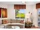 Cozy living room showcases a sectional sofa, stylish decor, and a large window with natural light at 3801 N Goldwater Blvd # 201, Scottsdale, AZ 85251