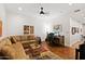 Spacious living room with a leather sofa, wood floors, ceiling fan and a desk with office space at 3801 N Goldwater Blvd # 201, Scottsdale, AZ 85251