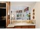 View through a pass-through of a bright living room with a chandelier at 3801 N Goldwater Blvd # 201, Scottsdale, AZ 85251