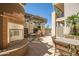 Elegant outdoor patio with fireplace, seating, grill, and dining, creating an inviting entertaining space at 3801 N Goldwater Blvd # 201, Scottsdale, AZ 85251
