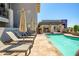 Relaxing pool area with lounge chairs and umbrellas near well-maintained condominiums at 3801 N Goldwater Blvd # 201, Scottsdale, AZ 85251