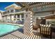 Community pool with sunshades, lounge seating, and fireplace, offering a relaxing outdoor space at 3801 N Goldwater Blvd # 201, Scottsdale, AZ 85251