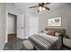 Inviting bedroom featuring a modern ceiling fan, contemporary decor, and ample closet space for a stylish and functional retreat at 41839 W Avella Dr, Maricopa, AZ 85138