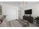 Cozy bedroom featuring soft, neutral tones, a ceiling fan, and a sleek TV console for a modern, comfortable living space at 41839 W Avella Dr, Maricopa, AZ 85138