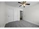Bedroom with neutral carpet, a ceiling fan, and sliding door closet at 41839 W Avella Dr, Maricopa, AZ 85138