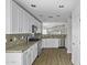 Contemporary kitchen featuring stainless steel appliances, ample white cabinetry, and granite countertops at 41839 W Avella Dr, Maricopa, AZ 85138