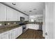 Well-lit kitchen with stainless steel appliances, granite countertops, and white cabinets for a modern feel at 41839 W Avella Dr, Maricopa, AZ 85138