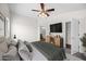 Comfortable main bedroom features neutral tones, ample closet space, and a ceiling fan for relaxation at 41839 W Avella Dr, Maricopa, AZ 85138