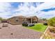 Expansive backyard with gravel, artificial turf, covered patio, and outdoor entertaining area at 4216 W Harwell Rd, Laveen, AZ 85339