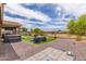 Spacious backyard featuring artificial turf, gravel landscaping, and an outdoor dining set at 4216 W Harwell Rd, Laveen, AZ 85339