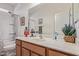 Well-lit bathroom featuring a shower-tub combination, a neutral color palette, and a spacious vanity at 4216 W Harwell Rd, Laveen, AZ 85339