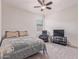 Cozy bedroom with a comfortable bed, a ceiling fan, and an entertainment center at 4216 W Harwell Rd, Laveen, AZ 85339
