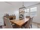 The dining room features a rustic wood table and modern light fixture at 4216 W Harwell Rd, Laveen, AZ 85339