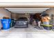 Organized garage featuring a parked car, storage solutions, and ample space at 4216 W Harwell Rd, Laveen, AZ 85339