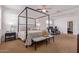 Spacious main bedroom with four poster bed, carpet flooring, and comfortable seating at 4216 W Harwell Rd, Laveen, AZ 85339