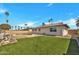 Spacious backyard featuring a pool, well-manicured lawn, and mature palm trees at 4720 W Northview Ave, Glendale, AZ 85301