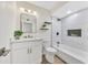Elegant bathroom featuring dual sinks, a decorative mirror, and a soaking tub and tiled shower perfect for relaxing at 4720 W Northview Ave, Glendale, AZ 85301