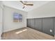 Bright bedroom featuring wood-look flooring, a ceiling fan, and decorative accent wall offers a cozy and welcoming space at 4720 W Northview Ave, Glendale, AZ 85301