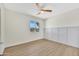 Spacious bedroom featuring wood-look flooring, a ceiling fan, decorative accent wall and natural light at 4720 W Northview Ave, Glendale, AZ 85301