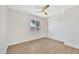 Well-lit bedroom features wood-look floors, ceiling fan and ample closet space at 4720 W Northview Ave, Glendale, AZ 85301