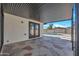 Spacious covered patio with stone flooring offering an ideal space for outdoor relaxation and entertaining with a view of the pool at 4720 W Northview Ave, Glendale, AZ 85301