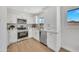 Bright kitchen with modern cabinets, stainless steel appliances, quartz countertops, and wood floors at 4720 W Northview Ave, Glendale, AZ 85301