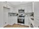 Updated kitchen with modern cabinets, stainless steel appliances, quartz countertops, and wood floors at 4720 W Northview Ave, Glendale, AZ 85301