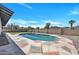 Inviting in-ground pool in a private backyard, surrounded by decorative rock and a well-maintained patio area at 4720 W Northview Ave, Glendale, AZ 85301
