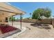 A backyard featuring a covered patio and well-maintained gravel landscaping at 6051 E Ensenada St, Mesa, AZ 85205