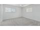 Neutral bedroom featuring two windows providing natural light and neutral carpeting at 6051 E Ensenada St, Mesa, AZ 85205
