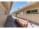 Exterior walkway features exercise and billiards rooms with convenient seating and outdoor charm at 6051 E Ensenada St, Mesa, AZ 85205