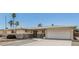 Charming single-story home with stone accents, desert landscaping, and an attached two-car garage at 6051 E Ensenada St, Mesa, AZ 85205