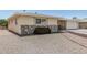 Well-maintained home with stone veneer and decorative window features, showcasing its curb appeal at 6051 E Ensenada St, Mesa, AZ 85205