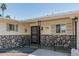 Inviting front porch with decorative ironwork and stone accents, enhancing the home's entry appeal at 6051 E Ensenada St, Mesa, AZ 85205
