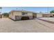 Charming home featuring stone accents and a well-manicured front yard at 6051 E Ensenada St, Mesa, AZ 85205