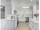 Bright, modern kitchen with stainless steel appliances, white cabinets, and new flooring at 6051 E Ensenada St, Mesa, AZ 85205