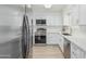 Modern kitchen with stainless steel appliances and white cabinets provides a clean, contemporary aesthetic at 6051 E Ensenada St, Mesa, AZ 85205